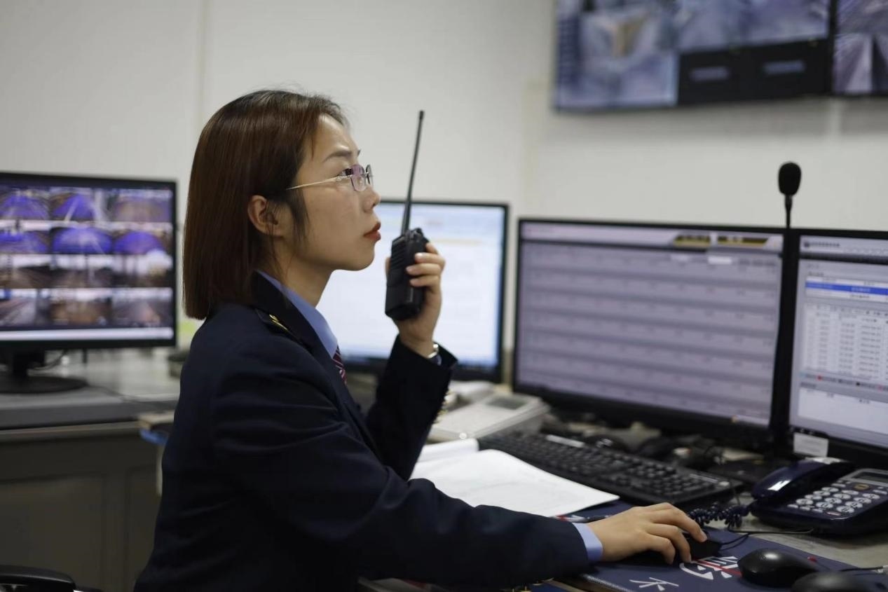 張華正在使用對(duì)講機(jī)溝通客運(yùn)工作情況。蔡紫妍攝