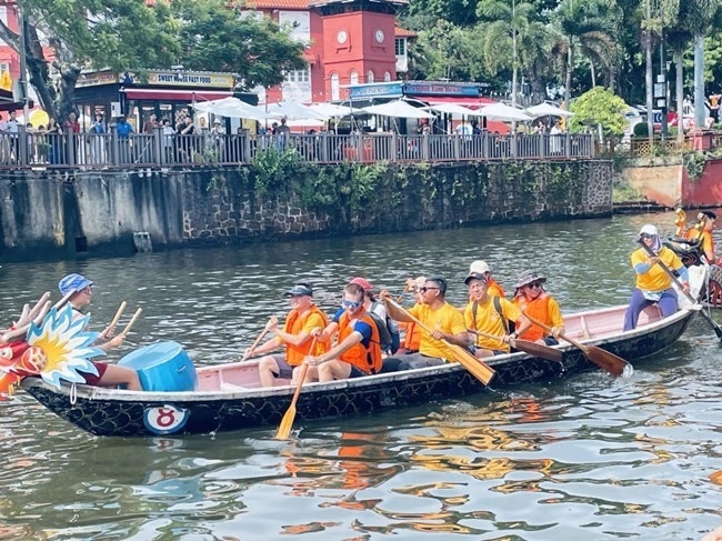 多元種族共同奮輯前進，體驗在馬六甲河劃龍舟，引來大批游客駐足圍觀。組委會供圖