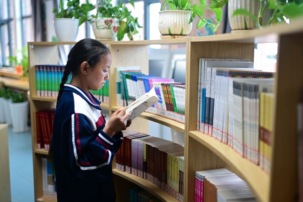 6月18日，果洛西寧民族中學(xué)學(xué)生尼東拉毛在圖書(shū)室看書(shū)。