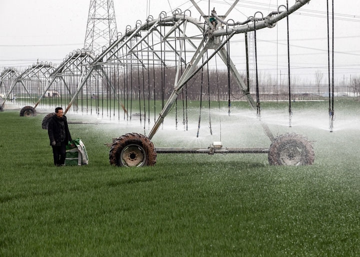 2024年3月18日，在河南省焦作市博愛縣孝敬鎮(zhèn)東原莊村瑞輝家庭農(nóng)場，村民使用全自動(dòng)指針式噴灌機(jī)進(jìn)行澆灌作業(yè)。新華社發(fā)（程全攝）