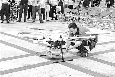 郵政工作人員取出無人機配送的高考錄取通知書。華南理工大學供圖