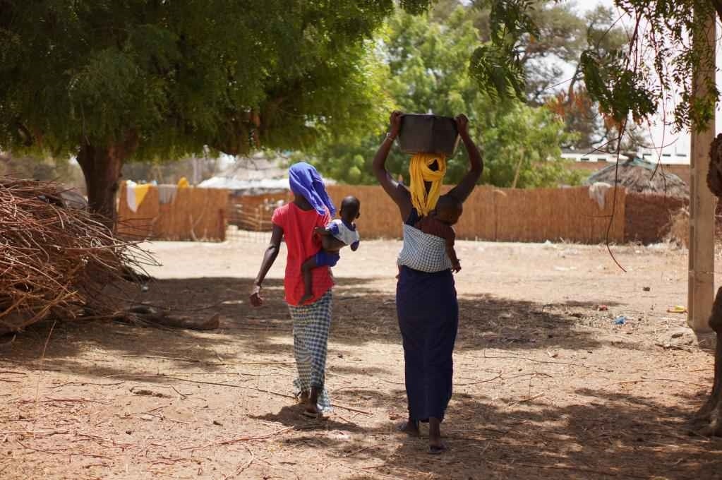 2023年3月20日，在塞內(nèi)加爾久爾貝勒區(qū)的泰內(nèi)富勒村，村民將取到的水運回家。新華社記者 王子正 攝