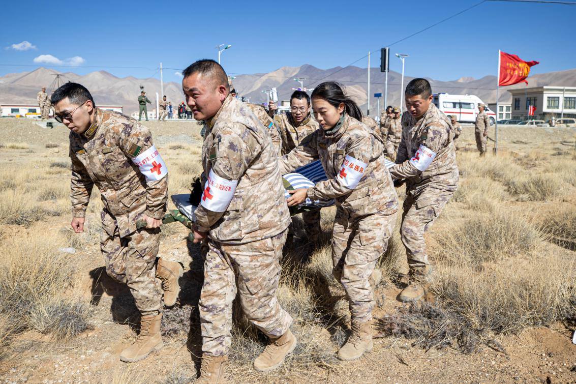 1月9日，日喀則定日縣長所鄉(xiāng)，西藏軍區(qū)總醫(yī)院醫(yī)療隊隊員將受傷村民用擔架從救護車準備抬上直升機，轉運至拉薩的西藏軍區(qū)總醫(yī)院救治。人民日報記者張武軍攝